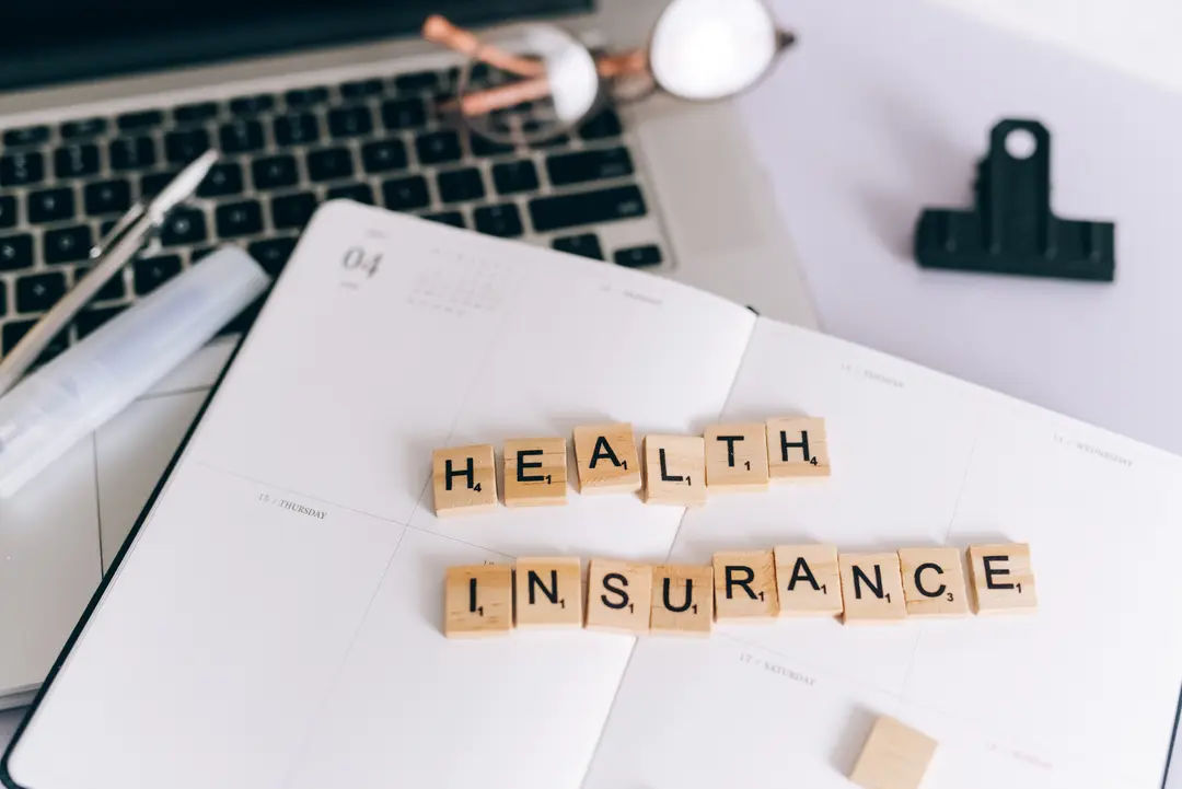 Health Insurance in Scrabble Letters on a Planner